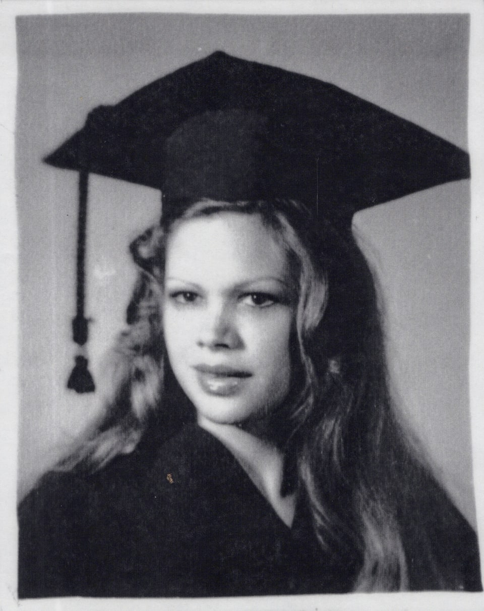 Black-and-white graduation portrait of Xiomara in a cap and gown.